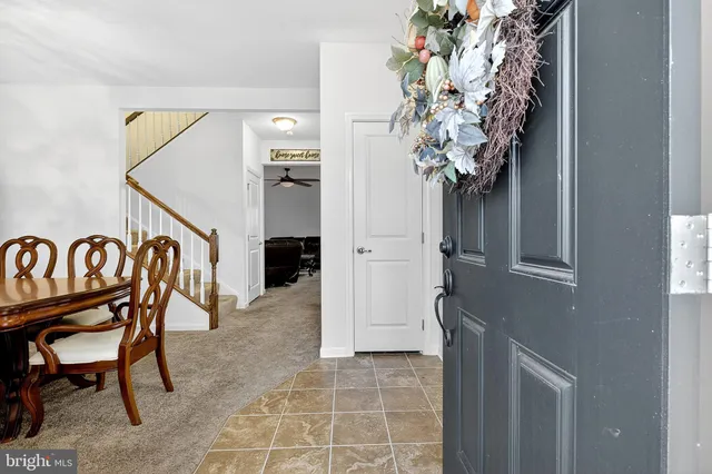 a dining room with furniture a chandelier and wooden floor