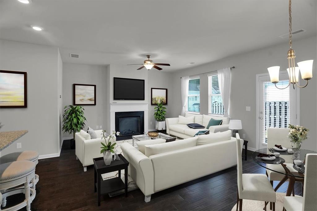 1506 Ashbrooke Trace Stone Mountain, GA 30083 - Photo 12 of 54 a living room with furniture a fireplace and a flat screen tv