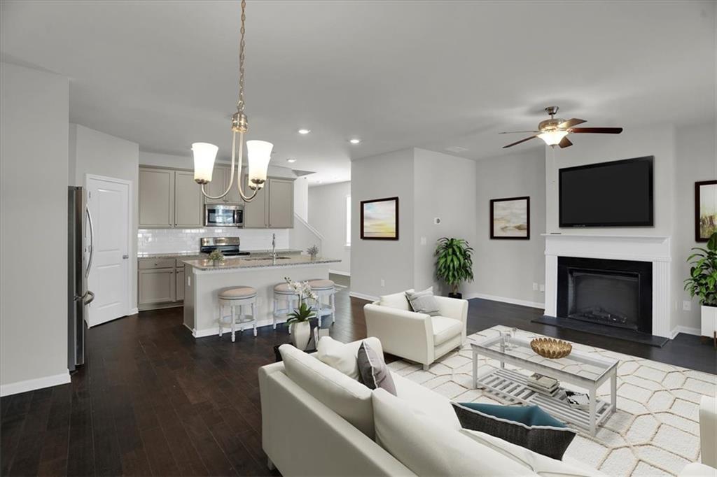 1506 Ashbrooke Trace Stone Mountain, GA 30083 - Photo 15 of 54 a living room with furniture a fireplace and a flat screen tv