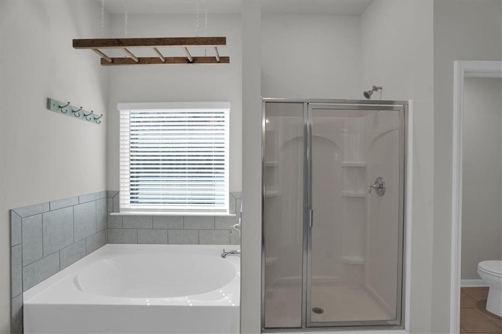 1506 Ashbrooke Trace Stone Mountain, GA 30083 - Photo 28 of 54 a bathroom with a bathtub and a shower
