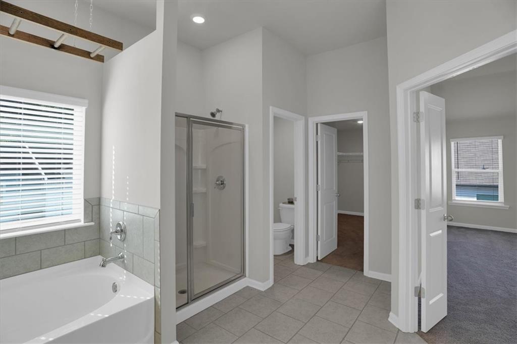 1506 Ashbrooke Trace Stone Mountain, GA 30083 - Photo 29 of 54 a bathroom with a bathtub and a shower