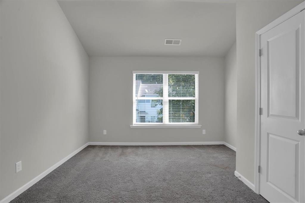 1506 Ashbrooke Trace Stone Mountain, GA 30083 - Photo 32 of 54 an empty room with a window