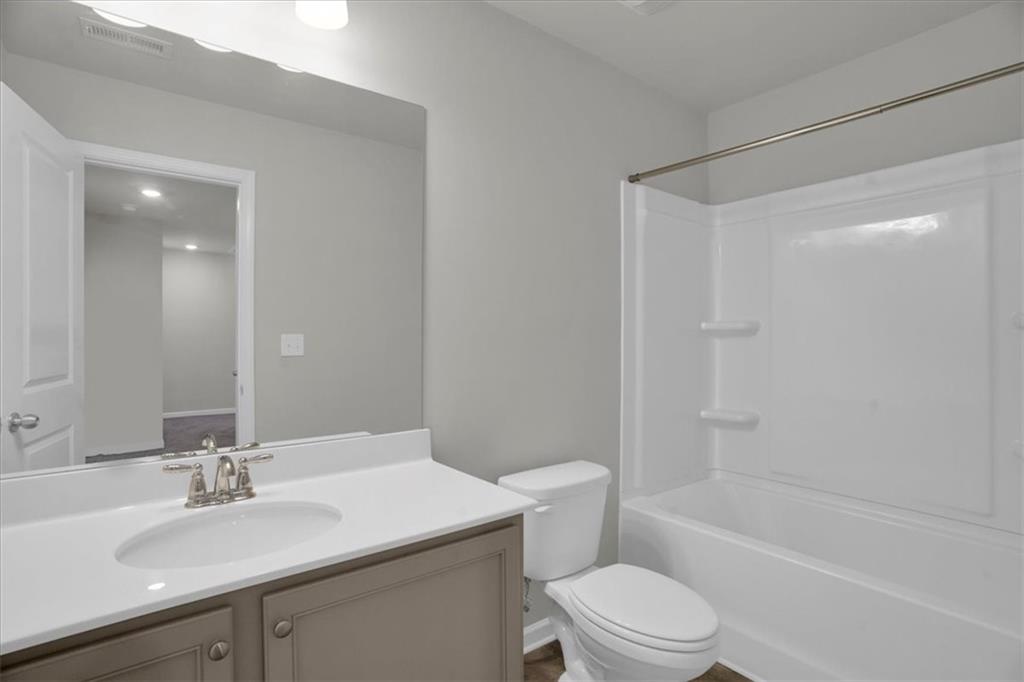 1506 Ashbrooke Trace Stone Mountain, GA 30083 - Photo 38 of 54 a bathroom with a sink a toilet and shower