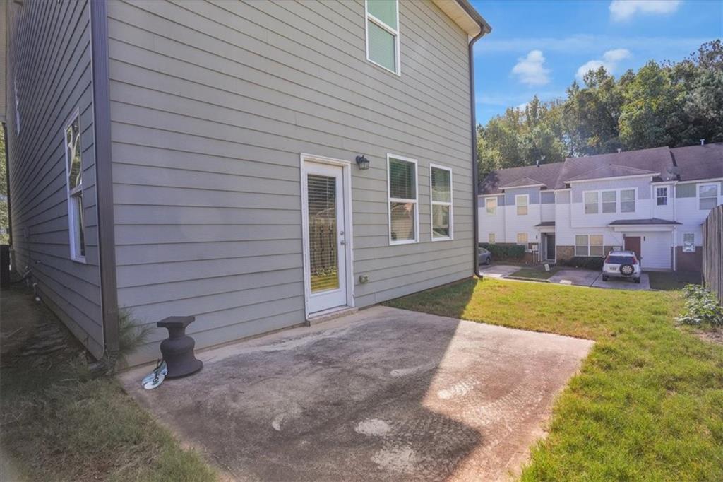1506 Ashbrooke Trace Stone Mountain, GA 30083 - Photo 47 of 54 a view of a house with a backyard
