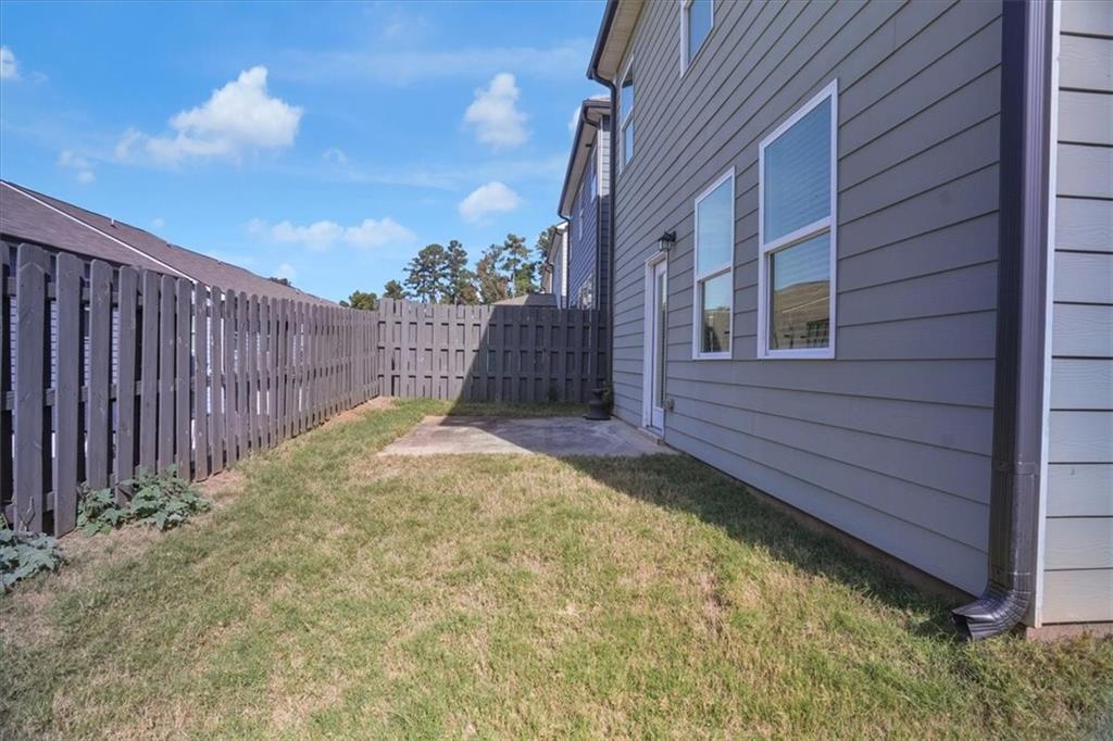 1506 Ashbrooke Trace Stone Mountain, GA 30083 - Photo 48 of 54 a view of a house with a wooden fence