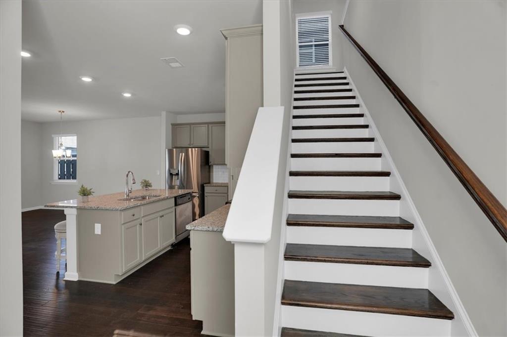 1506 Ashbrooke Trace Stone Mountain, GA 30083 - Photo 5 of 54 a kitchen with white cabinets and sink