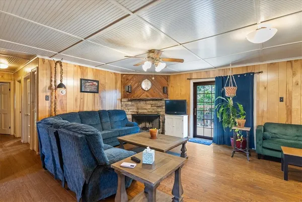 a living room with furniture a fireplace and a table