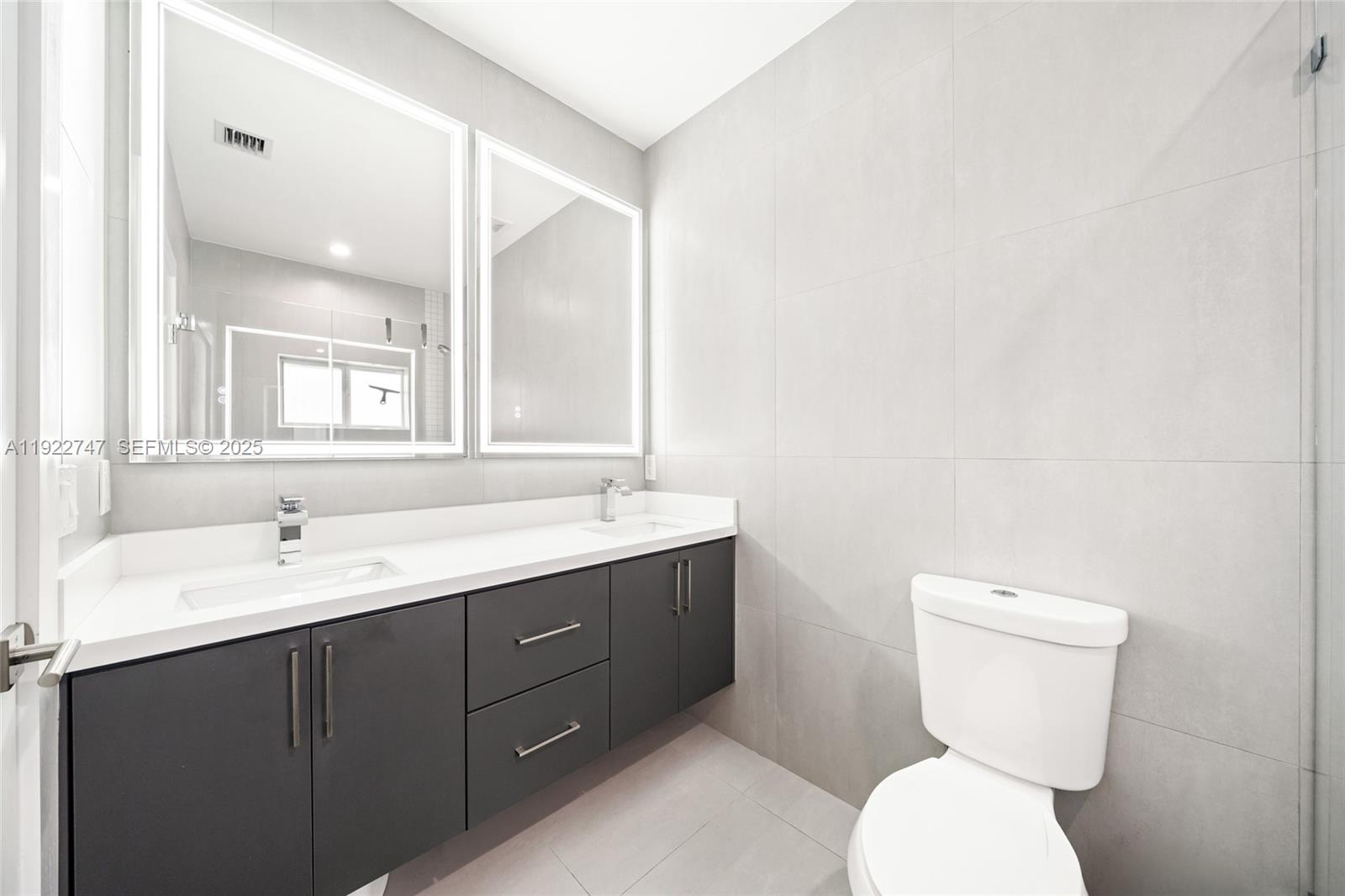 17341 Southwest 304th Street Homestead, FL 33030 - Photo 13 of 25 a bathroom with a toilet sink and mirror