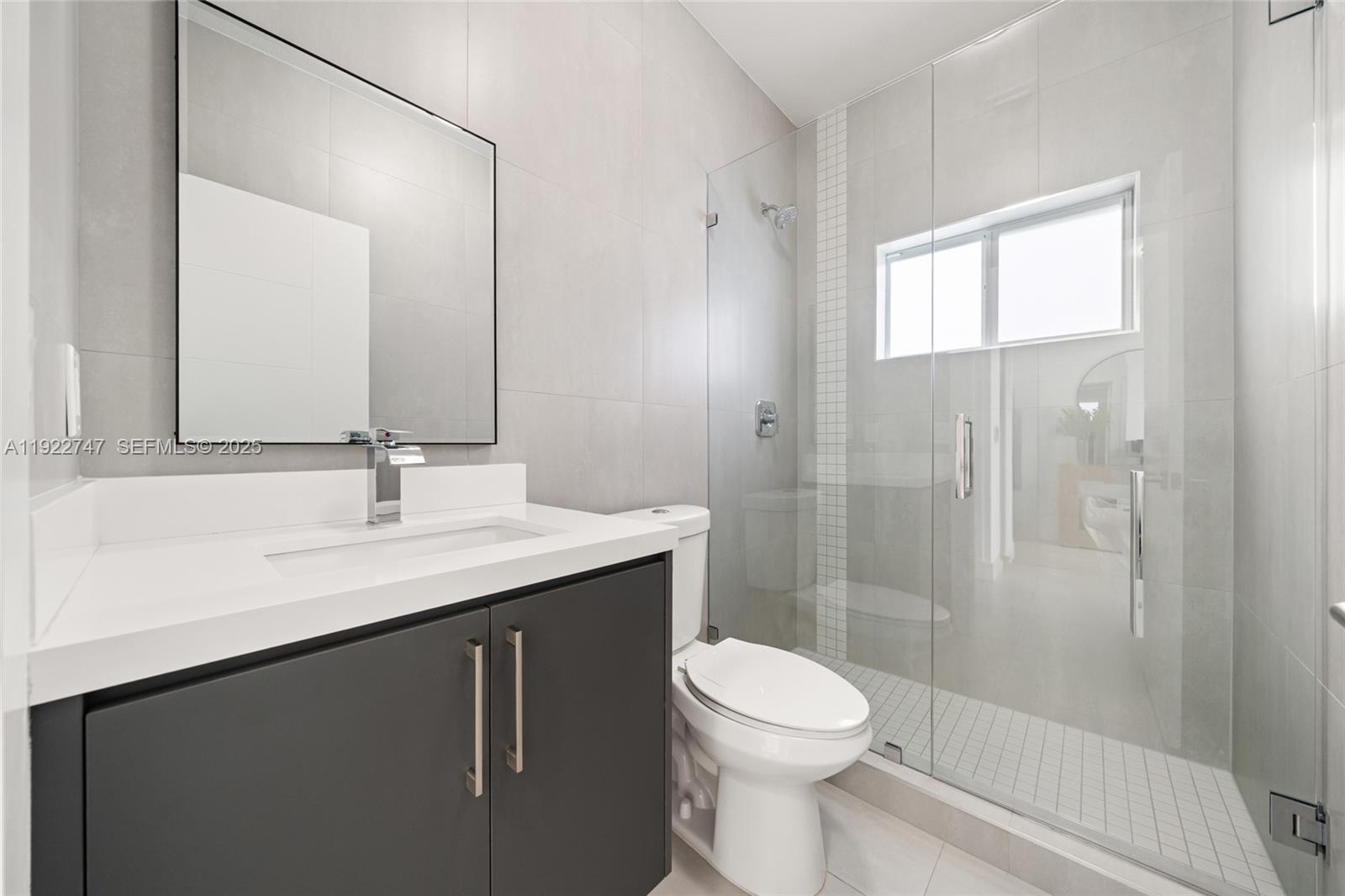 17341 Southwest 304th Street Homestead, FL 33030 - Photo 18 of 25 a bathroom with a sink a toilet and shower