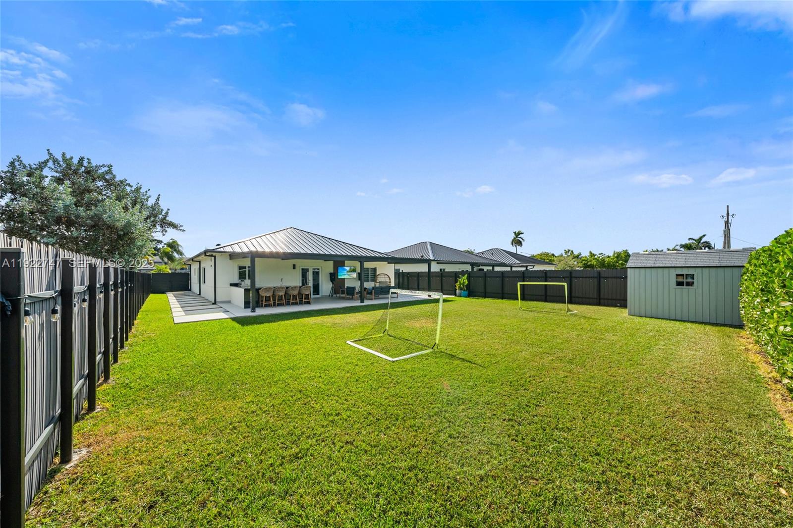 17341 Southwest 304th Street Homestead, FL 33030 - Photo 24 of 25 a view of a house with pool and a yard