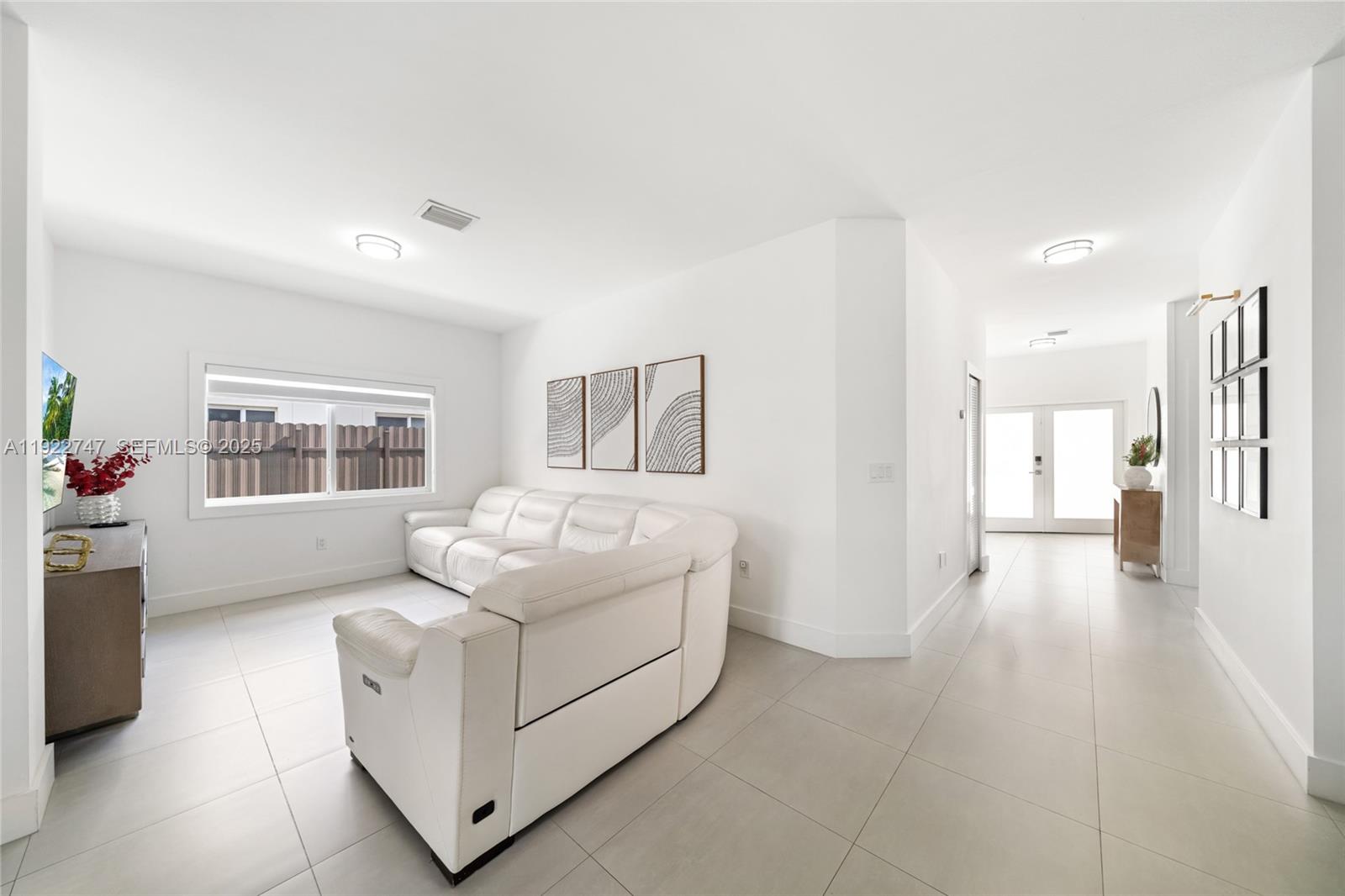 17341 Southwest 304th Street Homestead, FL 33030 - Photo 5 of 25 a living room with furniture and a window