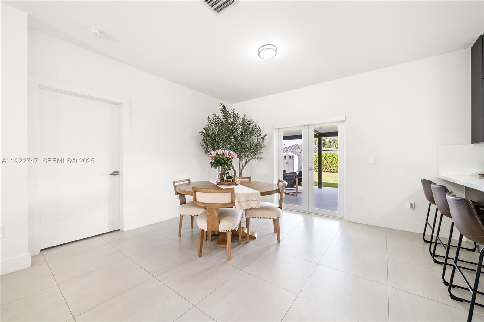 17341 Southwest 304th Street Homestead, FL 33030 - Photo 8 of 25 a dining room with furniture and a potted plant