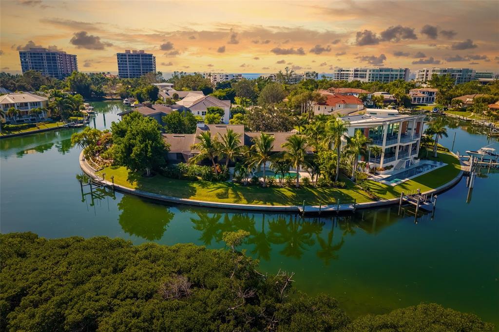 an aerial view of residential houses with outdoor space and lake view