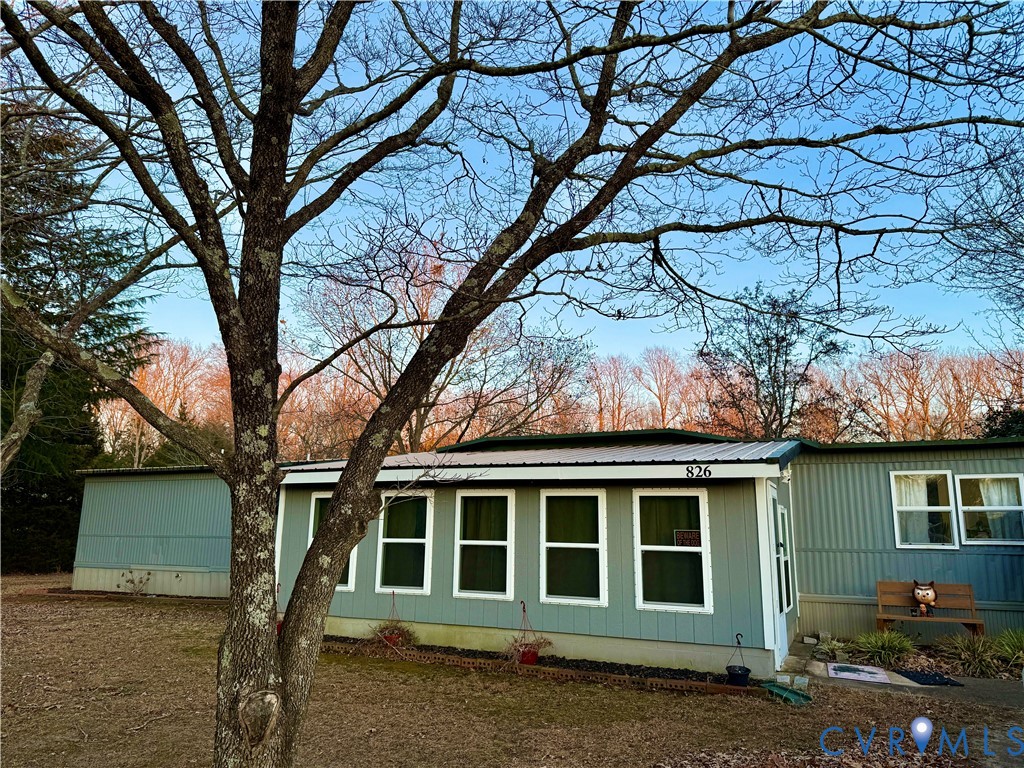 View of side of home featuring a metal roof