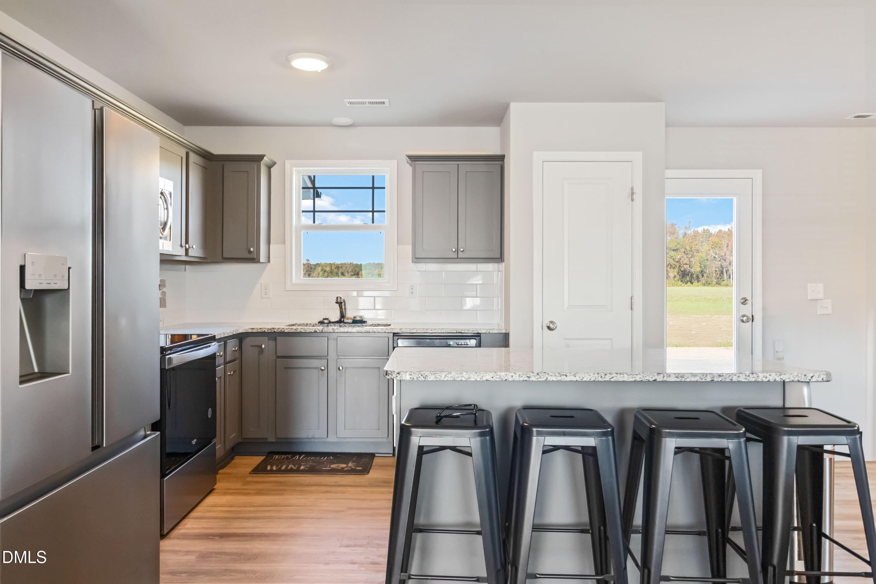 719 New Daniels Chapel Road Fremont, NC 27830 - Photo 3 of 24 a kitchen with stainless steel appliances granite countertop a stove a sink and a refrigerator