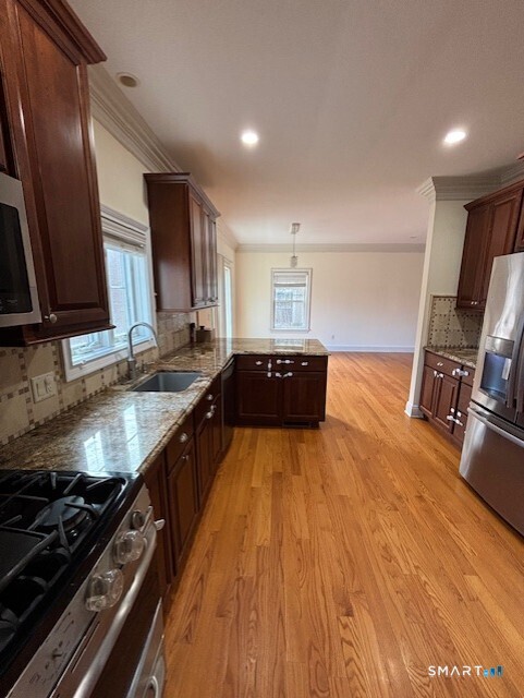 88 Maple Tree Avenue, Unit E Stamford, CT 06906 - Photo 12 of 50 a kitchen with granite countertop a stove and a sink