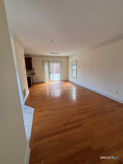 88 Maple Tree Avenue, Unit E Stamford, CT 06906 - Photo 13 of 50 wooden floor in an empty room with a window