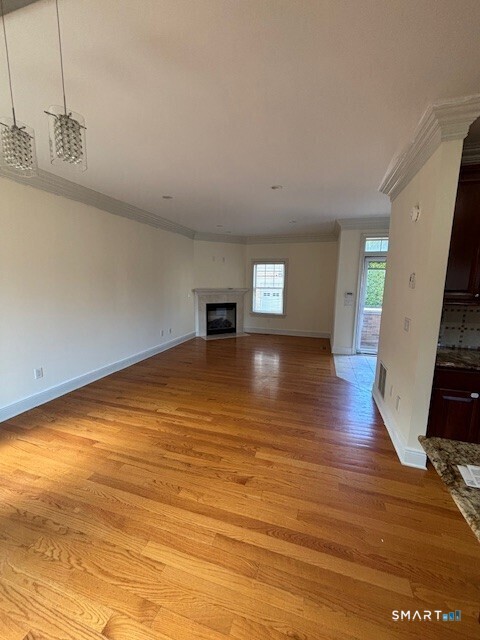 88 Maple Tree Avenue, Unit E Stamford, CT 06906 - Photo 16 of 50 a view of an empty room with wooden floor and a window