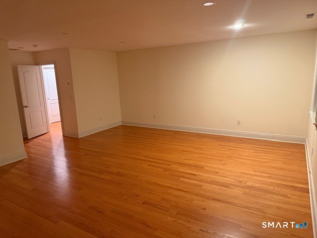 88 Maple Tree Avenue, Unit E Stamford, CT 06906 - Photo 19 of 50 an empty room with wooden floor and windows
