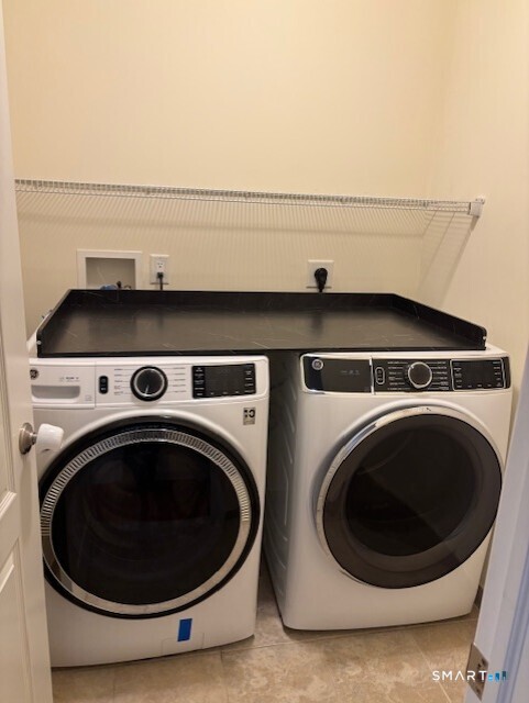 88 Maple Tree Avenue, Unit E Stamford, CT 06906 - Photo 22 of 50 a utility room with dryer and washer