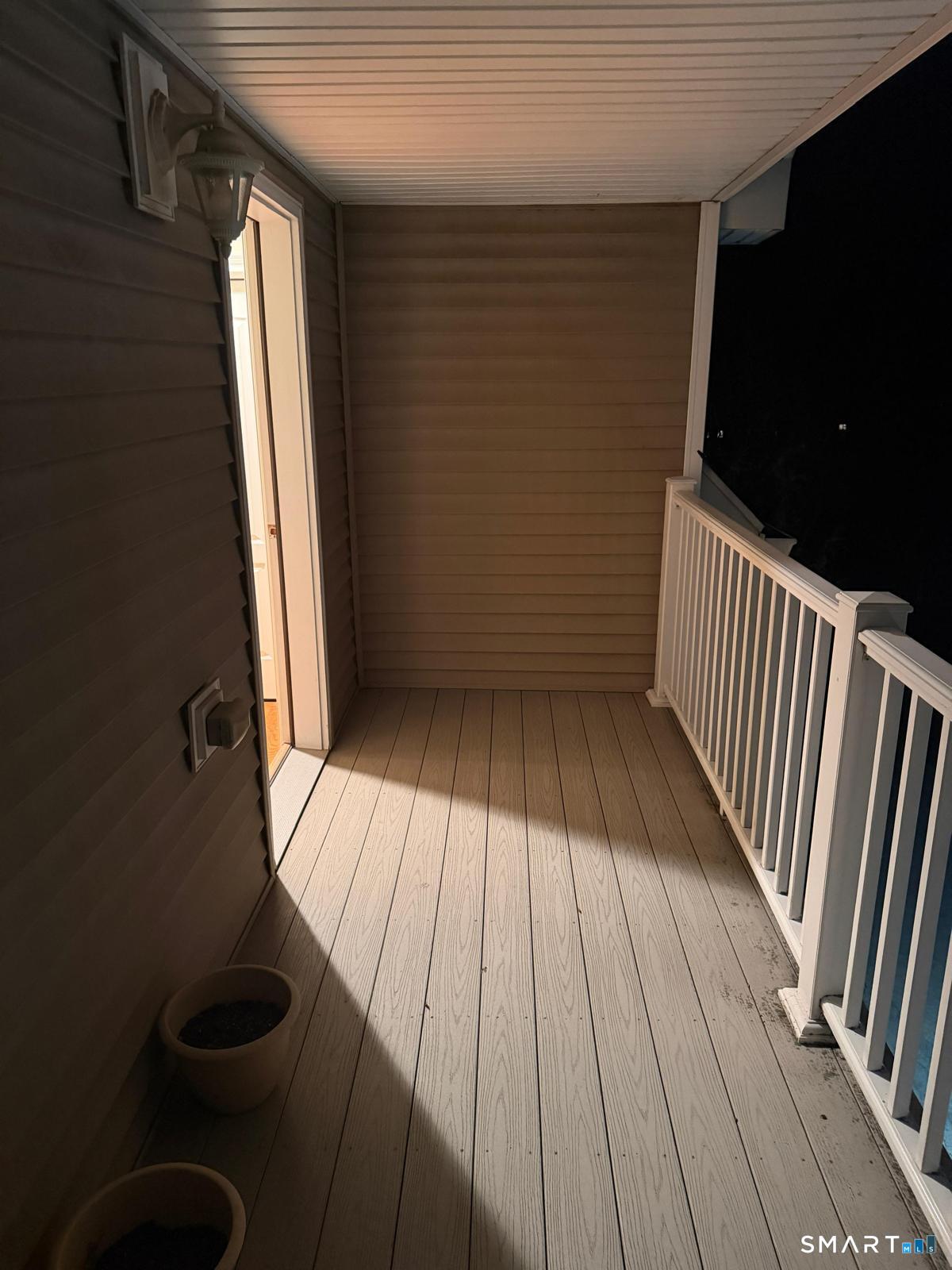 88 Maple Tree Avenue, Unit E Stamford, CT 06906 - Photo 26 of 50 a view of balcony with wooden floor