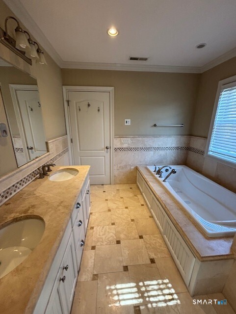 88 Maple Tree Avenue, Unit E Stamford, CT 06906 - Photo 27 of 50 a bathroom with a tub sink and mirror