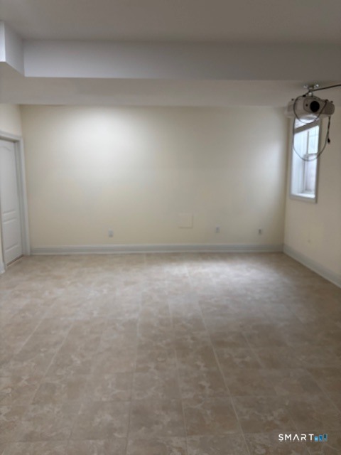 88 Maple Tree Avenue, Unit E Stamford, CT 06906 - Photo 32 of 50 an empty room with windows
