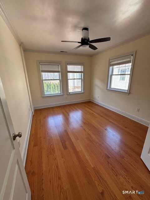 88 Maple Tree Avenue, Unit E Stamford, CT 06906 - Photo 37 of 50 a view of an empty room with wooden floor and a window