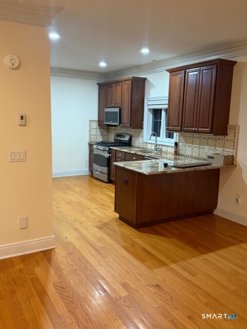 88 Maple Tree Avenue, Unit E Stamford, CT 06906 - Photo 4 of 50 a view of kitchen with stainless steel appliances granite countertop a sink and cabinets