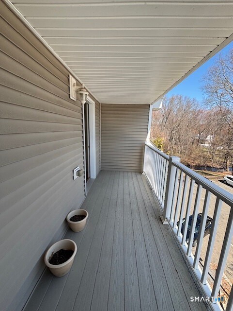 88 Maple Tree Avenue, Unit E Stamford, CT 06906 - Photo 44 of 50 a view of balcony with wooden floor