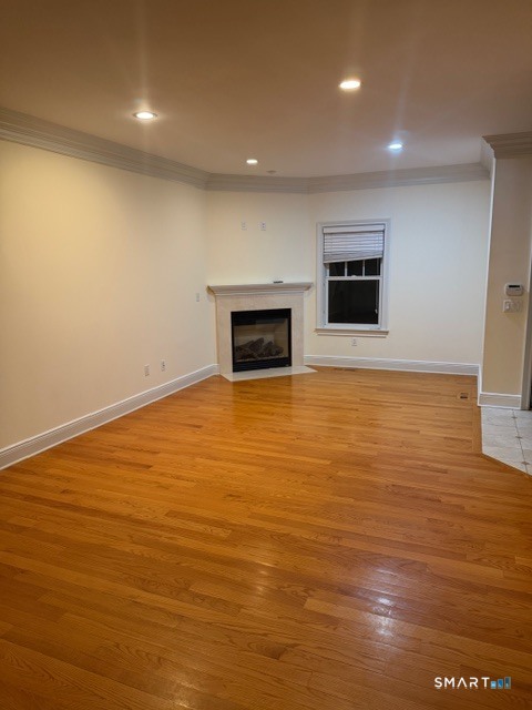 88 Maple Tree Avenue, Unit E Stamford, CT 06906 - Photo 6 of 50 a view of an empty room with a fireplace and a flat screen tv