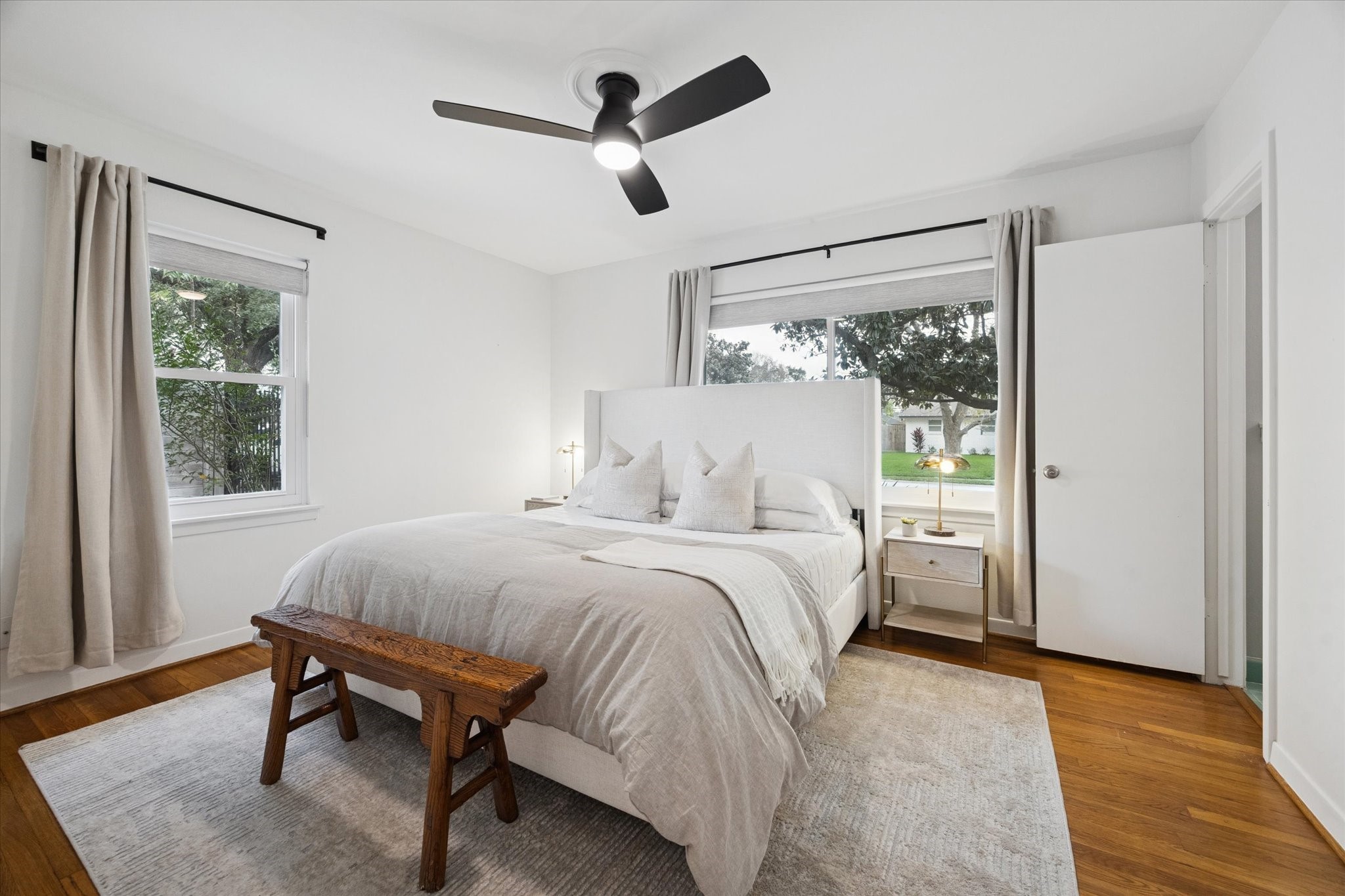 5234 Libbey Drive Houston, TX 77092 - Photo 22 of 35 The primary bedroom features hardwood floors, beautiful windows with coverings, a sleek ceiling fan, closet and an ensuite half bath.