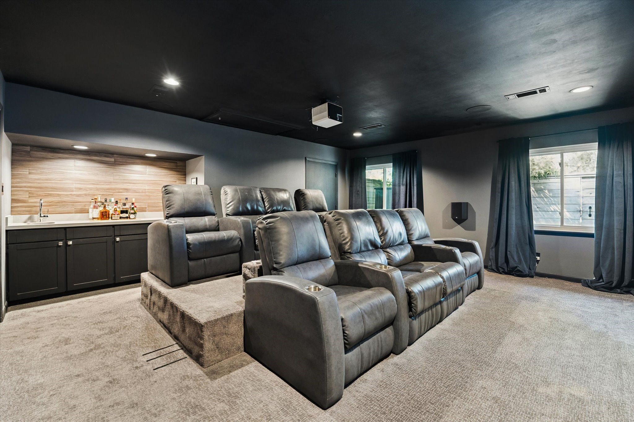 5234 Libbey Drive Houston, TX 77092 - Photo 3 of 35 Look at this unexpected room! The home theater is complete with stadium seating for eight and a quartz countertop wet bar with beverage fridge.
