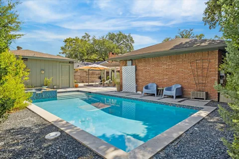 a view of a house with backyard and sitting area