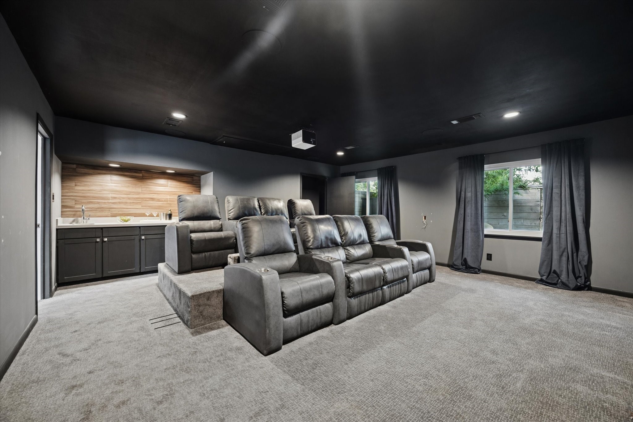 5234 Libbey Drive Houston, TX 77092 - Photo 4 of 35 Look at this unexpected room! The home theater is complete with stadium seating for eight and a quartz countertop wet bar with beverage fridge.