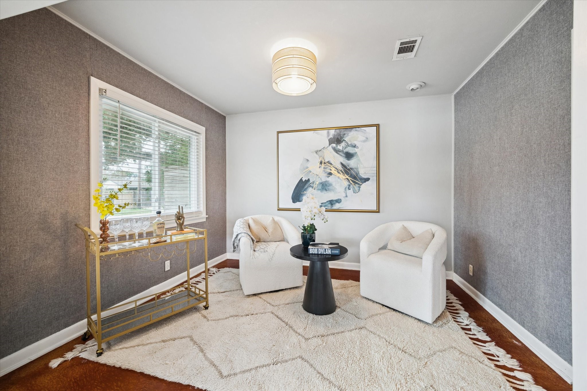 5234 Libbey Drive Houston, TX 77092 - Photo 8 of 35 The lounge exudes a cool vibe with stained concrete floors and textured wallpaper. The room opens to the dining room and kitchen, making it ideal for entertaining.