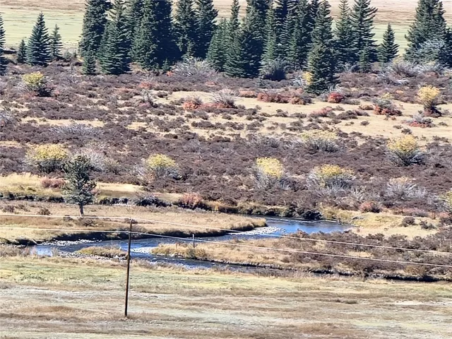 a view of a yard with wooden fence
