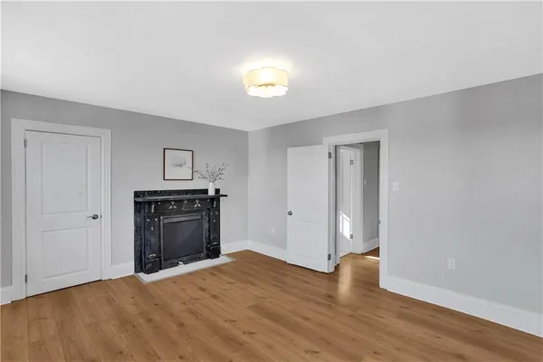 a big room with wooden floor and natural light