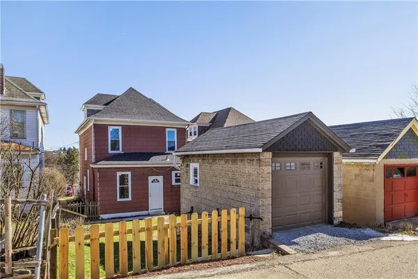 a front view of a house with a wooden fence