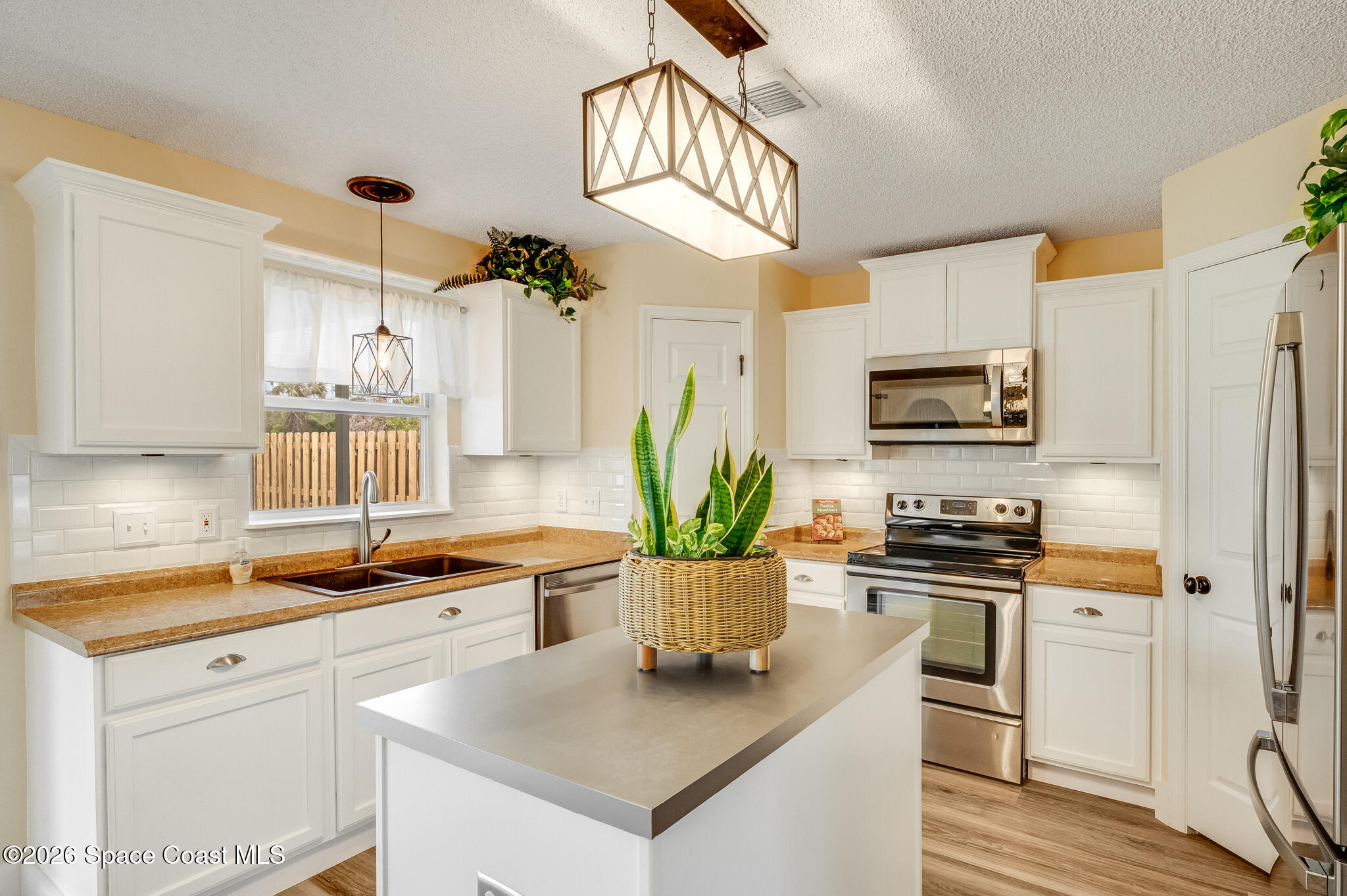 2250 Spring Creek Circle Palm Bay, FL 32905 - Photo 12 of 84 a kitchen with appliances a sink and cabinets