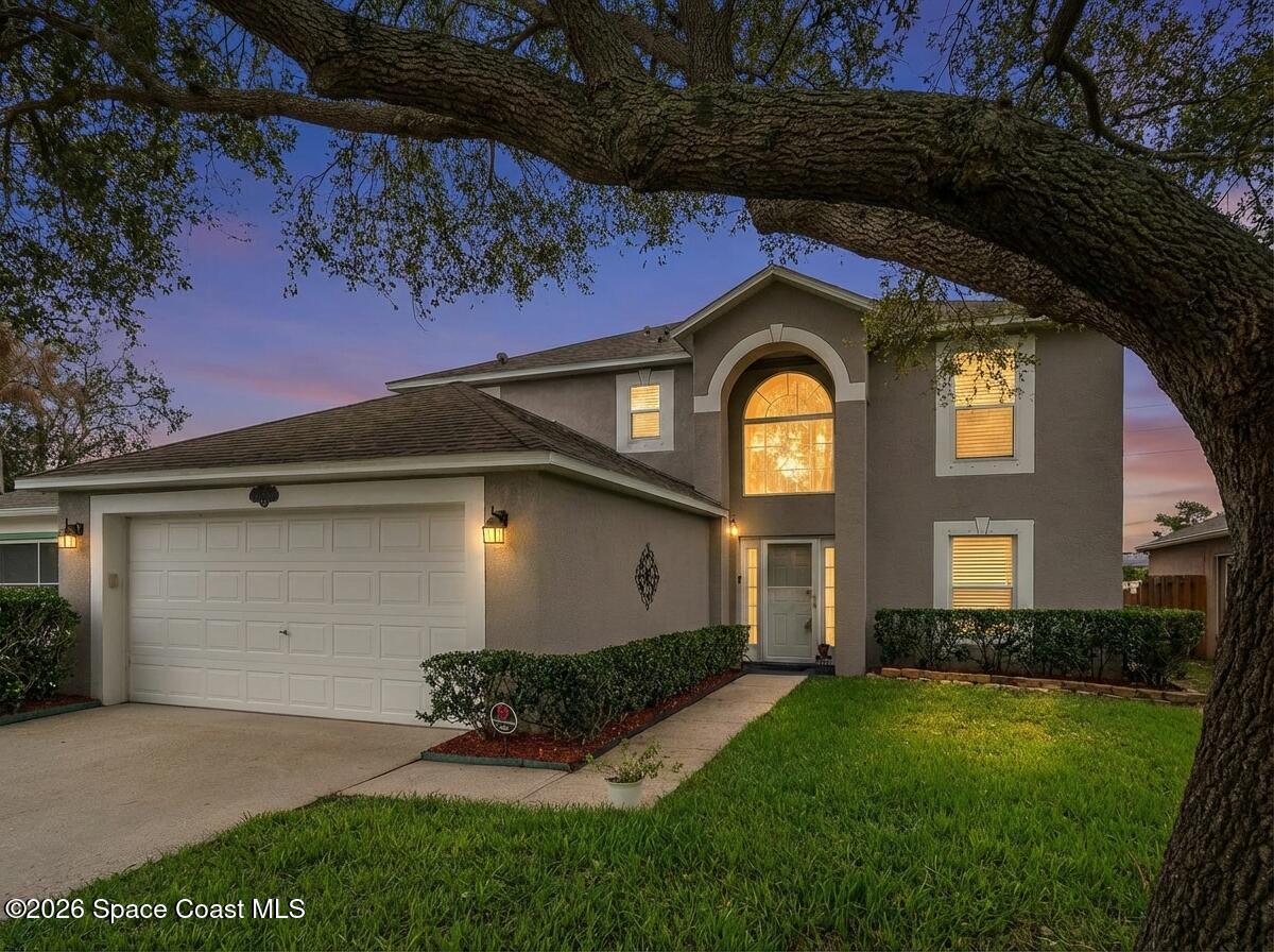 2250 Spring Creek Circle Palm Bay, FL 32905 - Photo 2 of 84 a front view of a house with garden