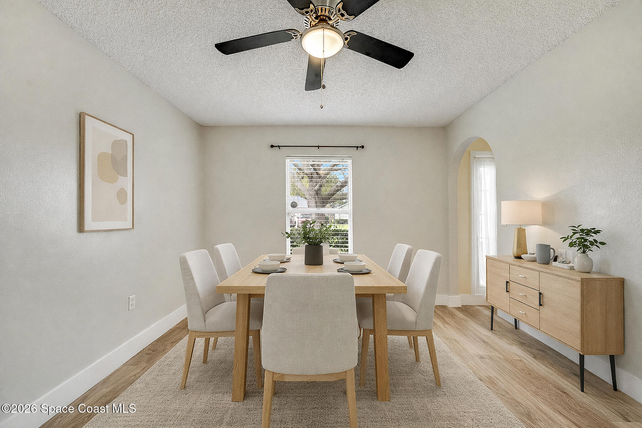 2250 Spring Creek Circle Palm Bay, FL 32905 - Photo 21 of 84 a dining room with furniture a chandelier and a window
