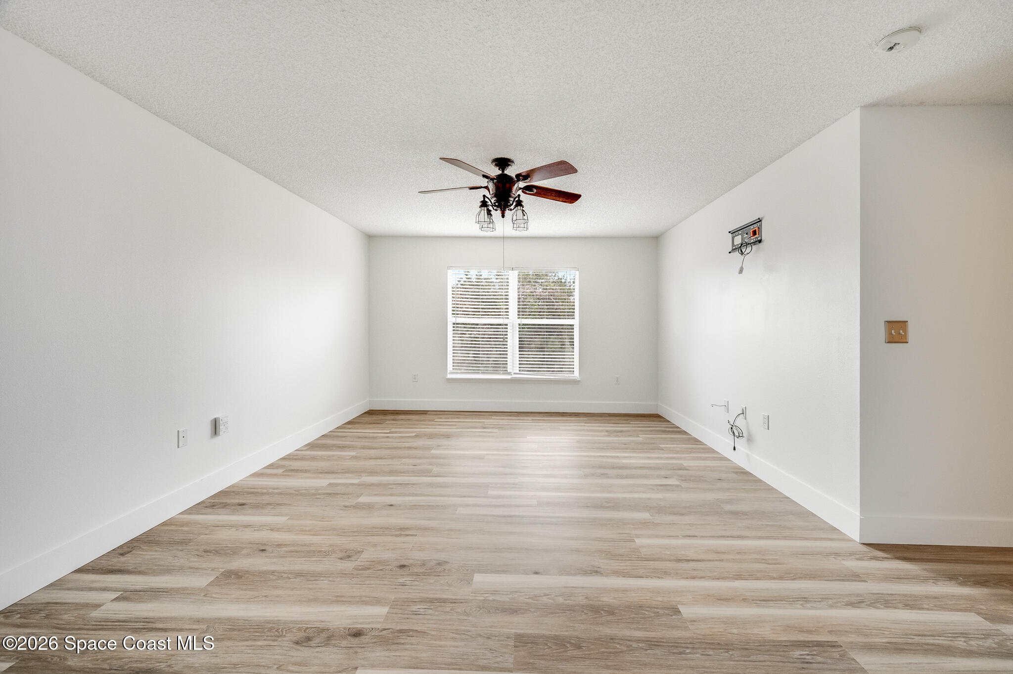 2250 Spring Creek Circle Palm Bay, FL 32905 - Photo 23 of 84 wooden floor in an empty room with a window