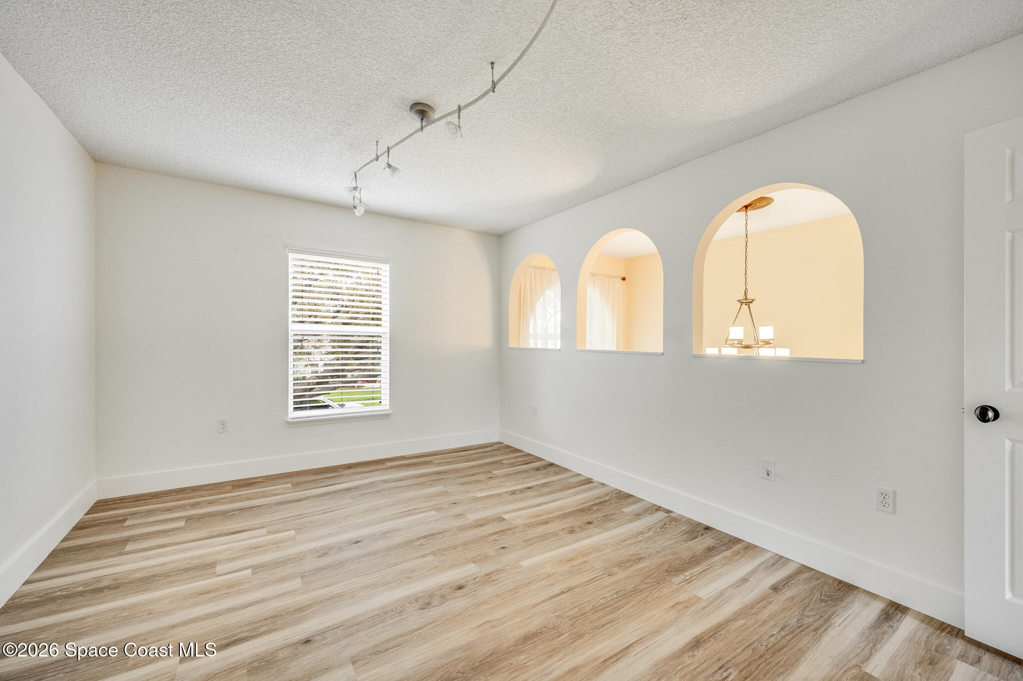 2250 Spring Creek Circle Palm Bay, FL 32905 - Photo 26 of 84 a view of an empty room with wooden floor and a window