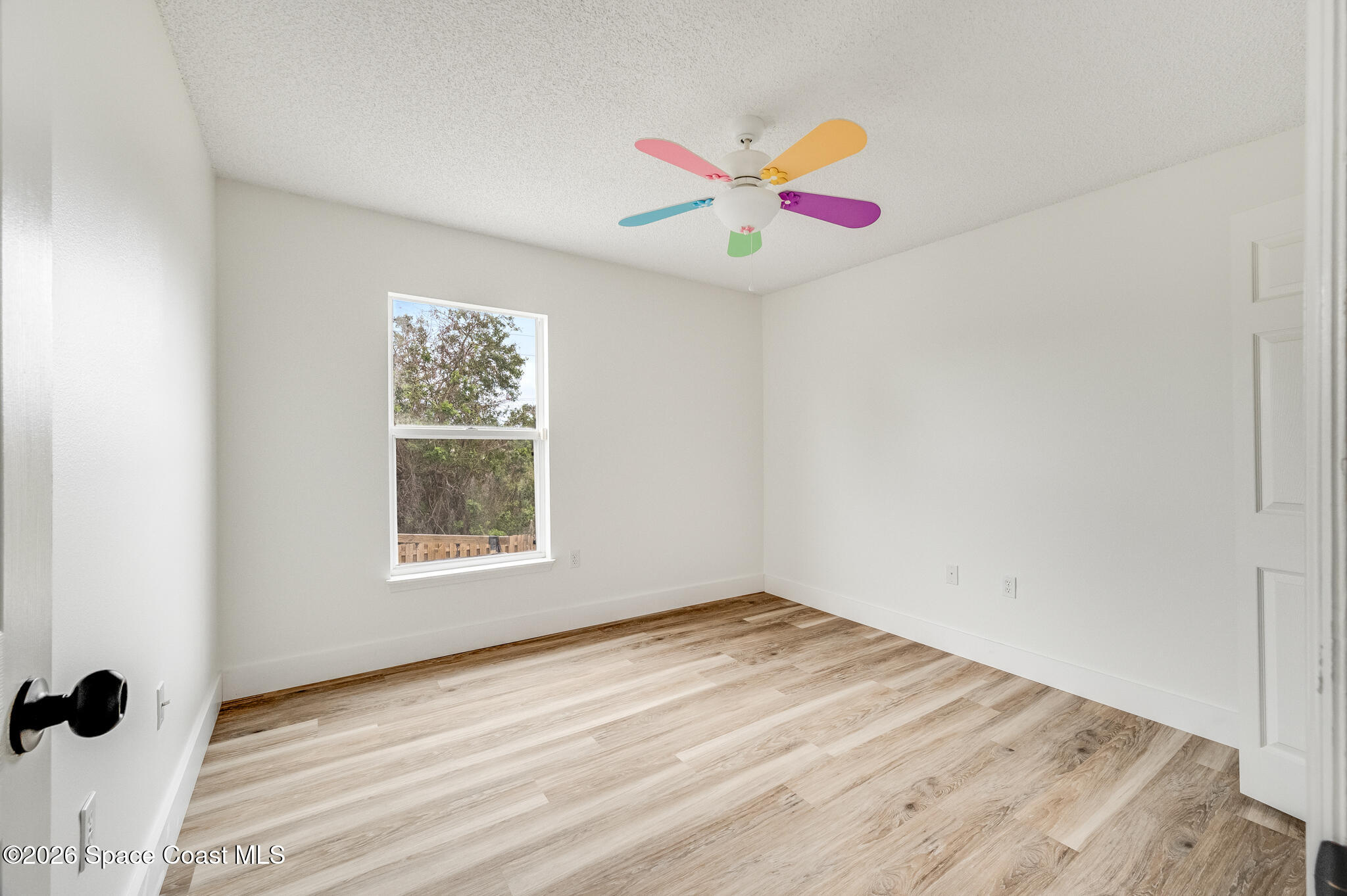 2250 Spring Creek Circle Palm Bay, FL 32905 - Photo 28 of 84 an empty room with a piano and a window