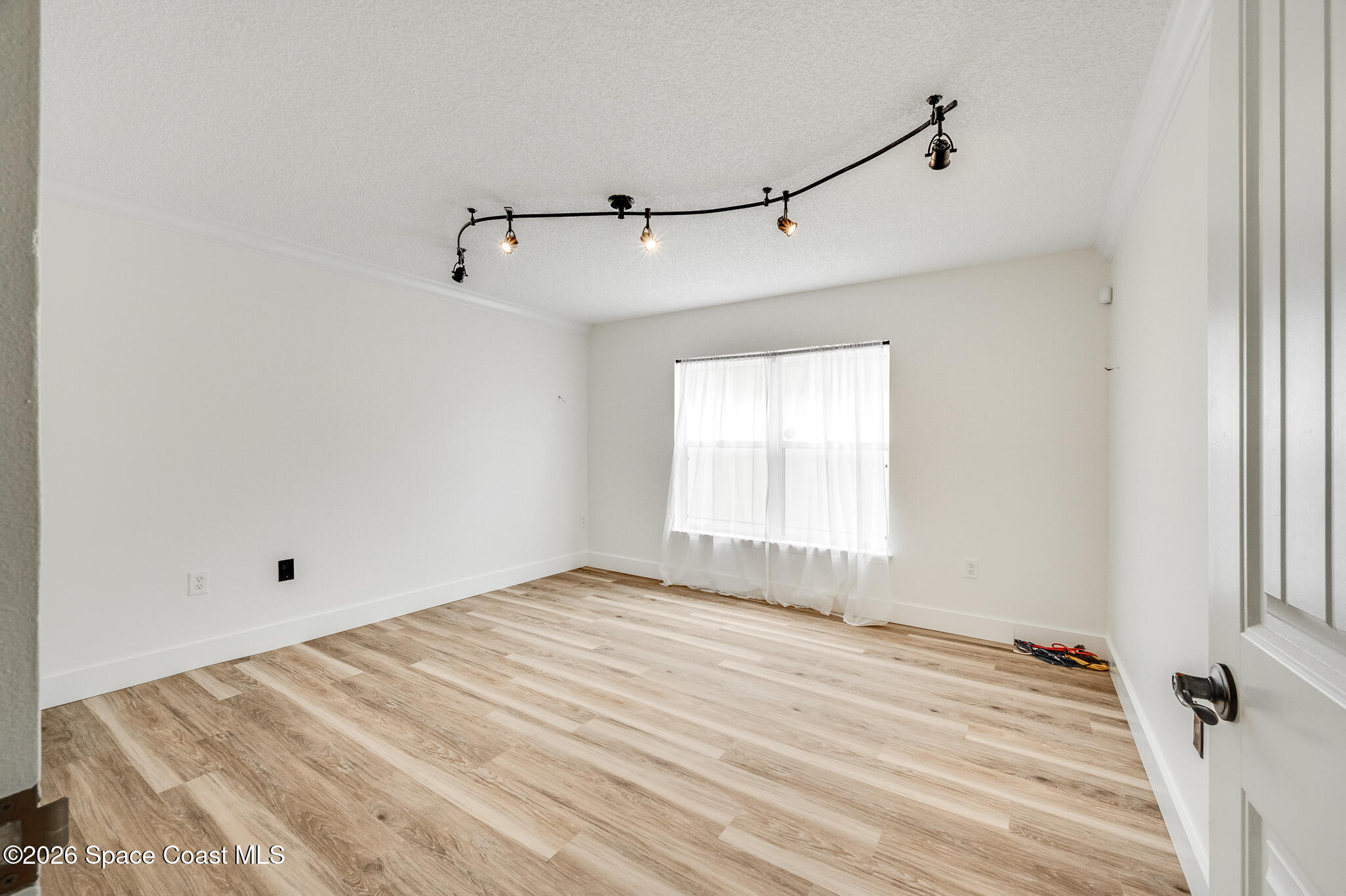 2250 Spring Creek Circle Palm Bay, FL 32905 - Photo 35 of 84 a view of empty room with wooden floor and fan