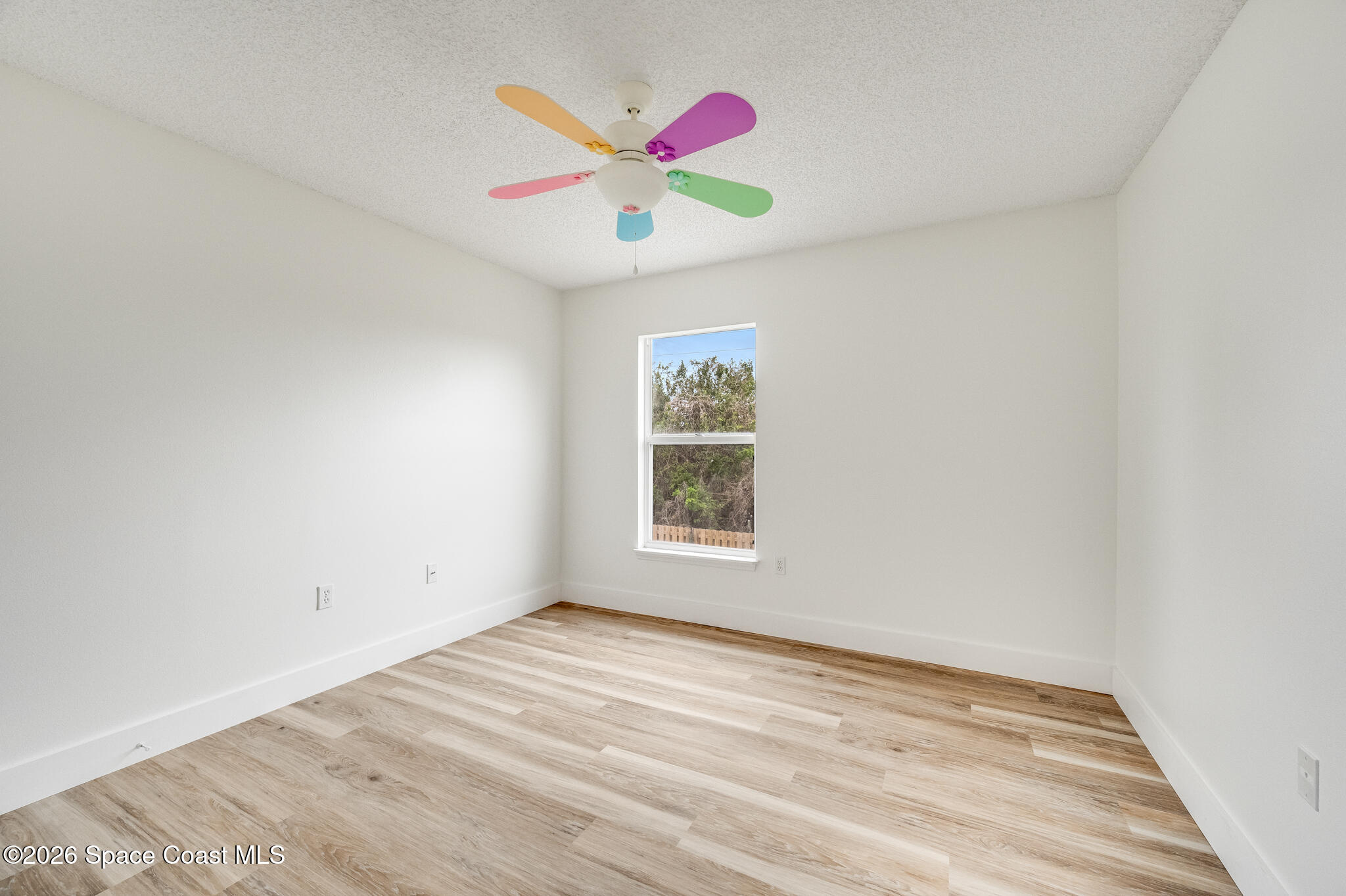 2250 Spring Creek Circle Palm Bay, FL 32905 - Photo 48 of 84 a view of an empty room with window and ceiling fan