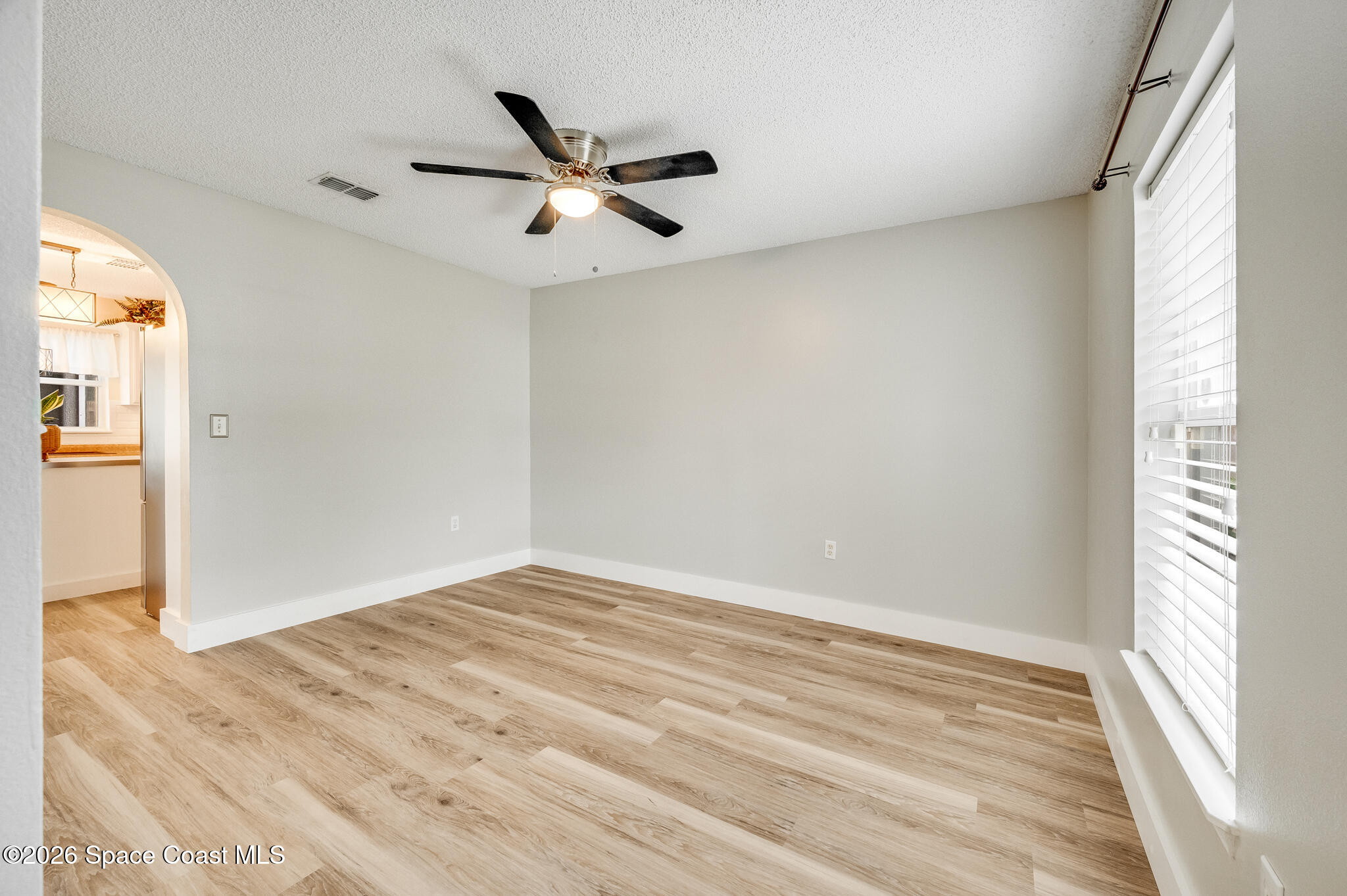 2250 Spring Creek Circle Palm Bay, FL 32905 - Photo 51 of 84 a view of a big room with wooden floor closet and windows