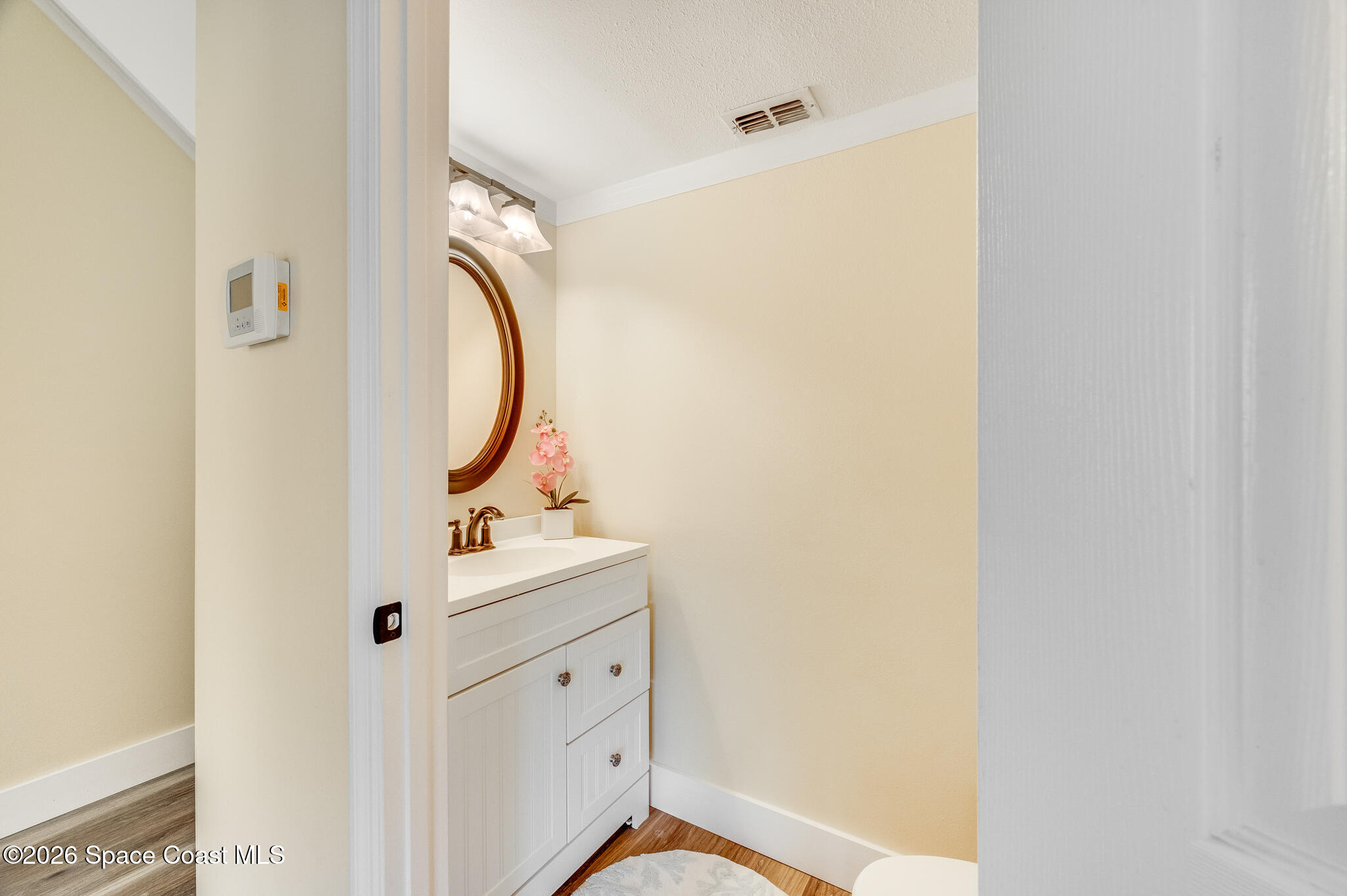 2250 Spring Creek Circle Palm Bay, FL 32905 - Photo 55 of 84 a bathroom with a sink mirror and vanity