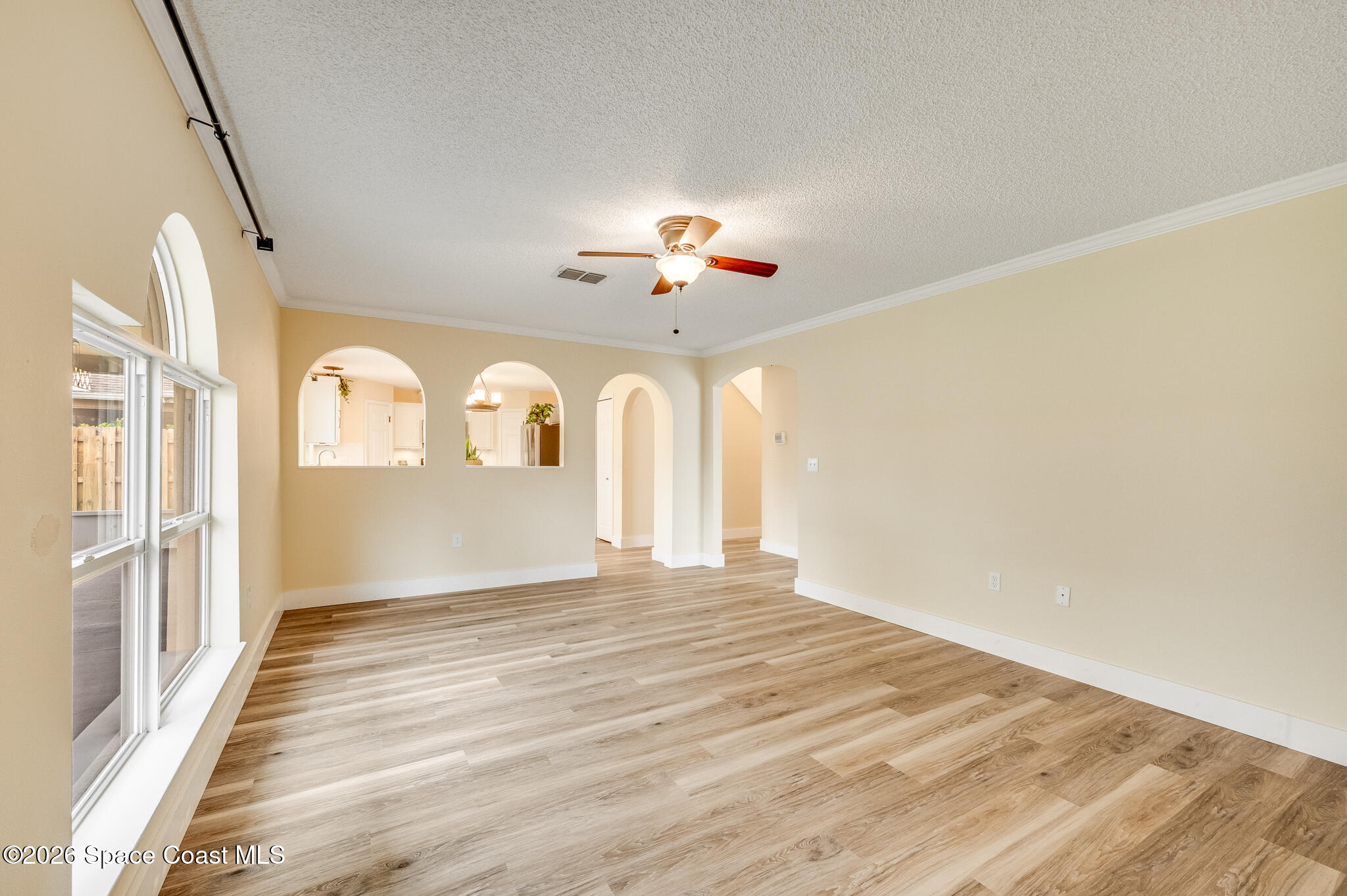 2250 Spring Creek Circle Palm Bay, FL 32905 - Photo 59 of 84 a view of a living room with a ceiling fan